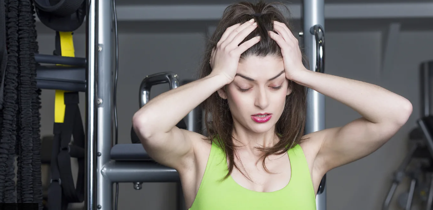 Woman holding her head in her hands