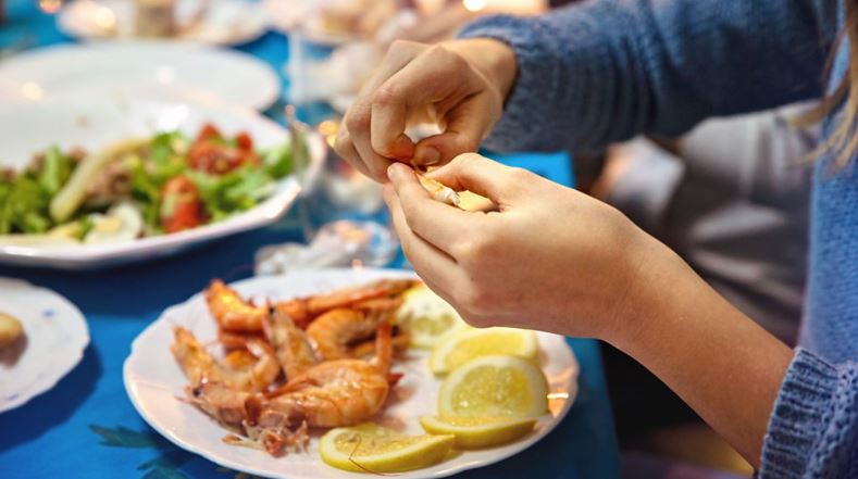 Person peeling prawns - Diet that could cut dementia risk by 25%